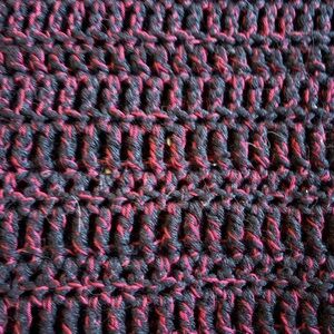 Cozy hand crocheted Throw Blanket in black and red with silver thread.